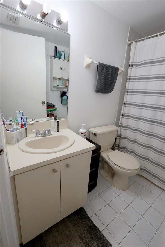 bathroom with tile patterned flooring, vanity, curtained shower, and toilet