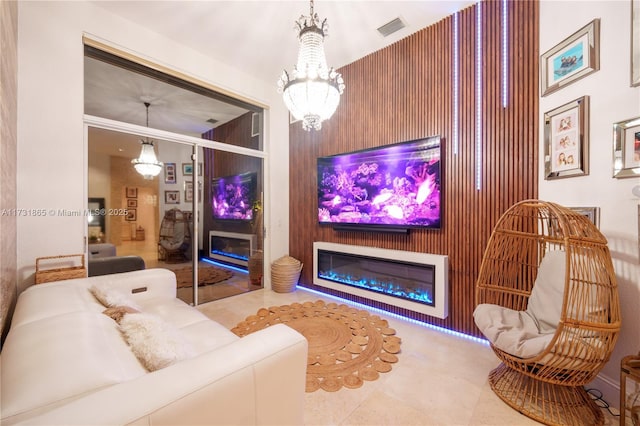 tiled home theater with wooden walls and a notable chandelier