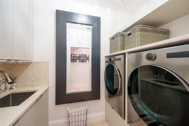 clothes washing area featuring sink and washer and clothes dryer