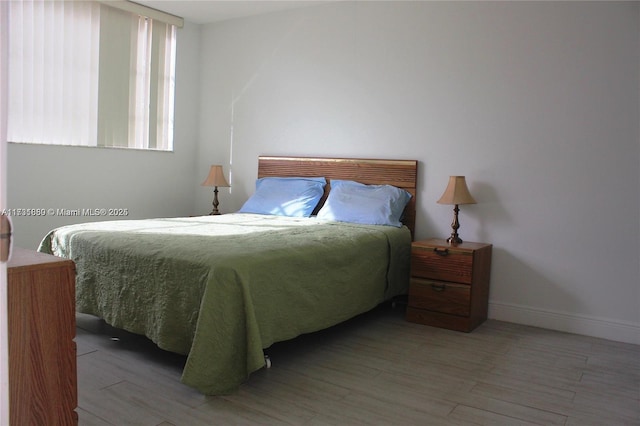 bedroom with hardwood / wood-style flooring