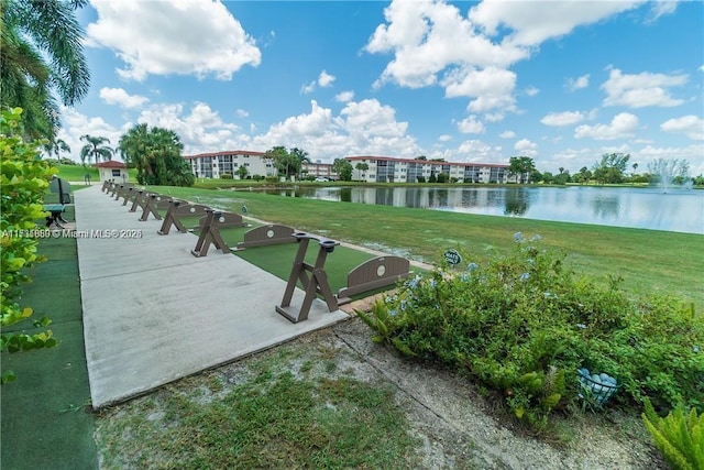 view of community with a water view and a yard