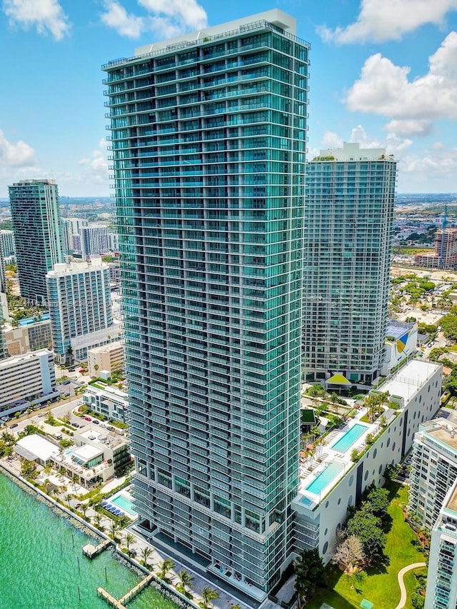 view of property with a water view and a view of city