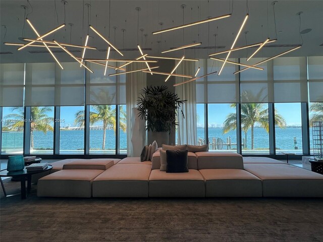 carpeted living room with a water view