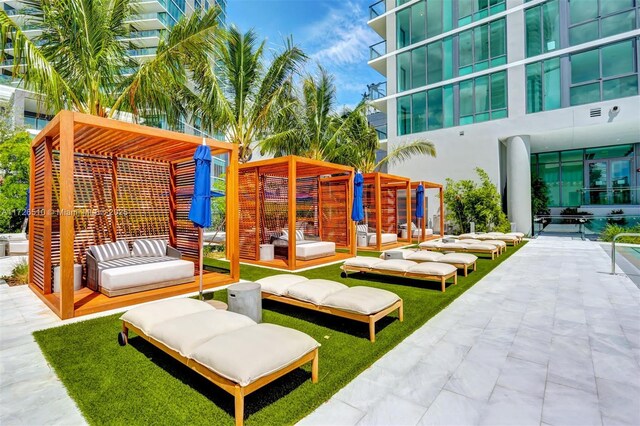 exterior space featuring an outdoor hangout area and a pergola