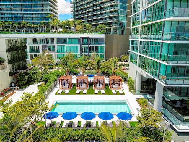 view of pool with a patio area and a pool with connected hot tub