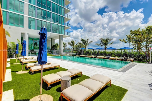 community pool featuring a patio and fence