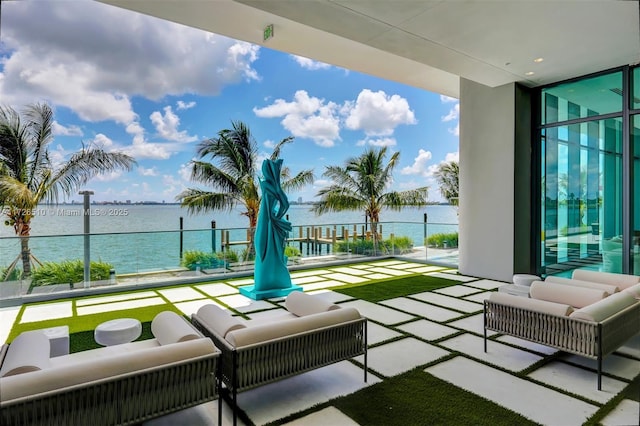 balcony with outdoor lounge area and a water view