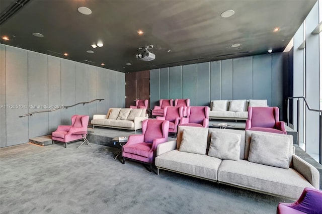 home theater room featuring a decorative wall and carpet flooring