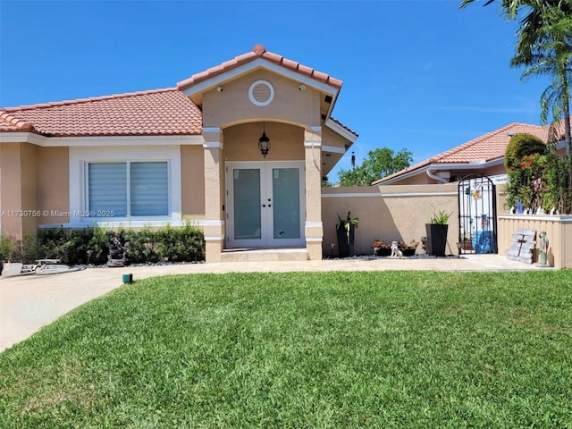 exterior space with a front yard and french doors