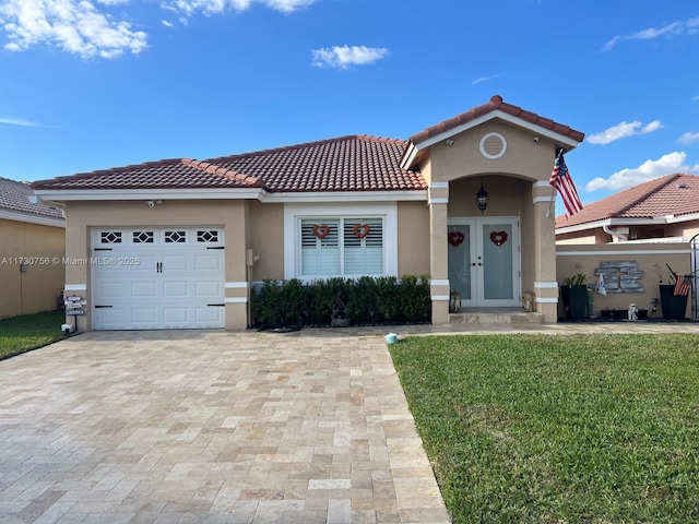 mediterranean / spanish house with a garage and a front yard