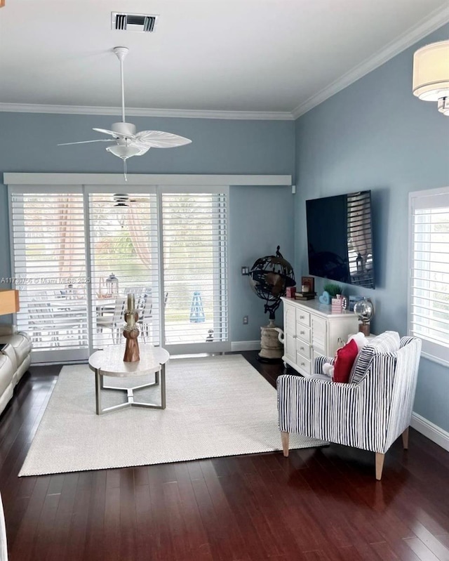 living room featuring crown molding, ceiling fan, and dark wood-type flooring