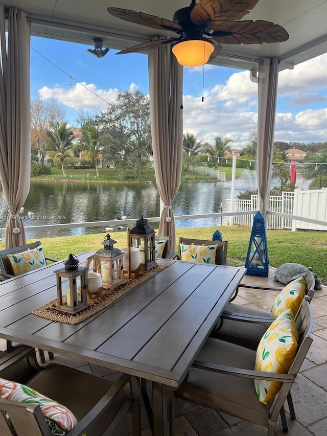 view of patio / terrace with ceiling fan and a water view