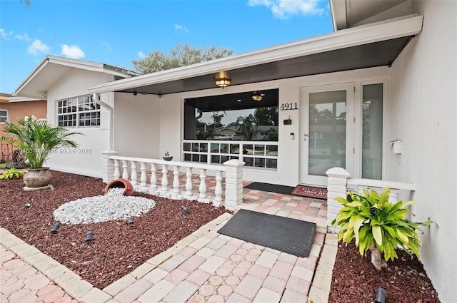 view of exterior entry with a porch