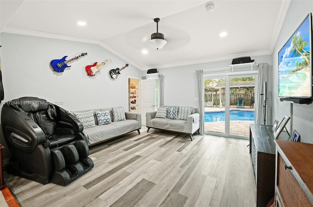 living room featuring ornamental molding, lofted ceiling, and light hardwood / wood-style floors