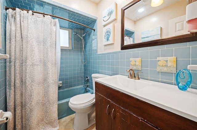 full bathroom with vanity, toilet, tile walls, and shower / bath combo