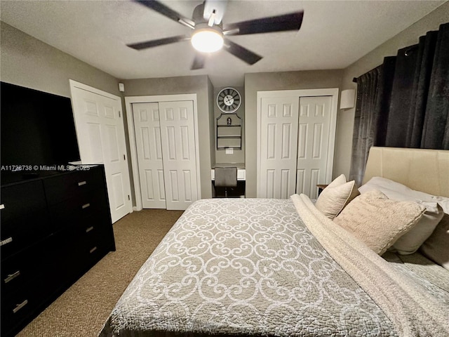 carpeted bedroom with multiple closets and ceiling fan