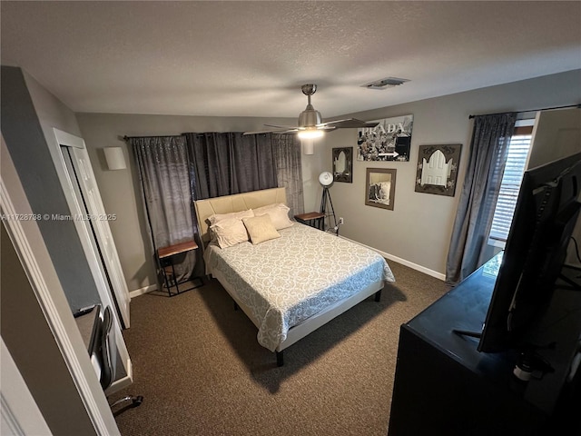 carpeted bedroom with ceiling fan and a textured ceiling