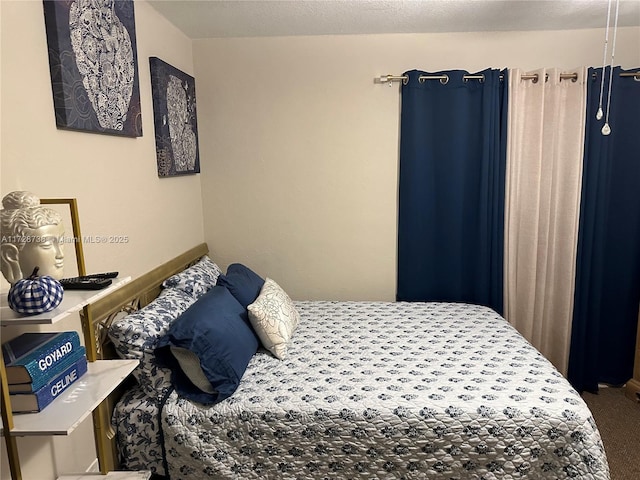 bedroom with carpet floors and a textured ceiling