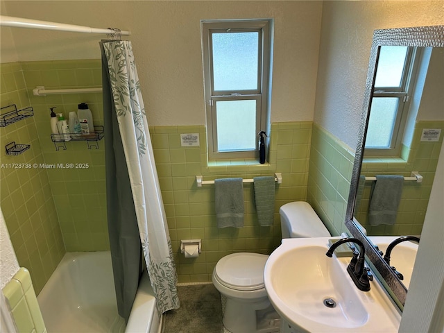 full bathroom with toilet, shower / bathtub combination with curtain, sink, and tile walls