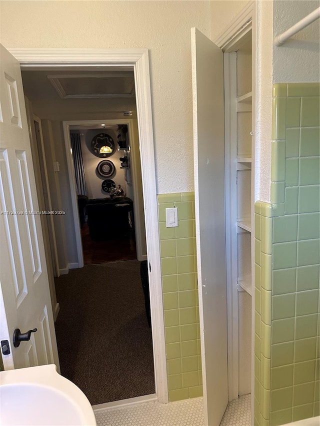 bathroom with sink, tile patterned flooring, and tile walls