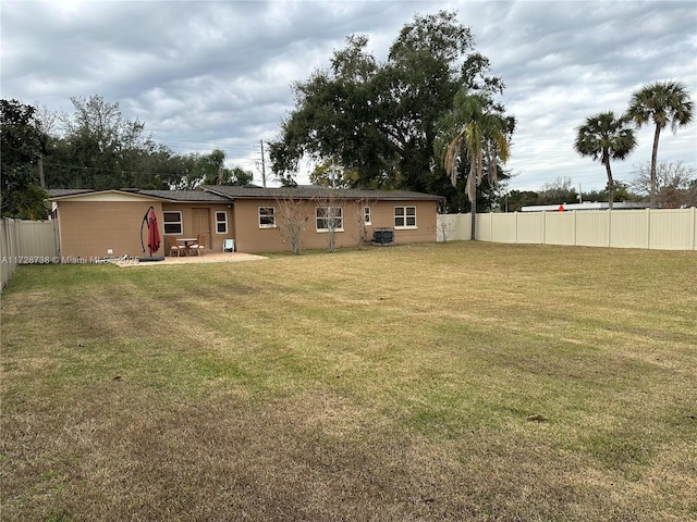 view of yard with central AC and a patio area