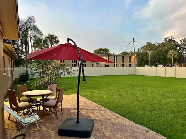 view of yard with cooling unit and a patio