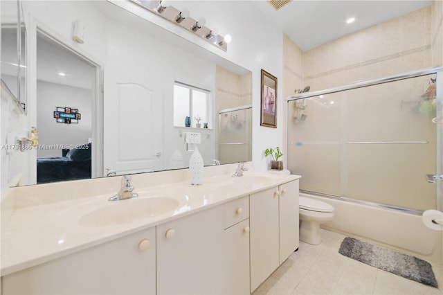 full bathroom with vanity, tile patterned flooring, enclosed tub / shower combo, and toilet