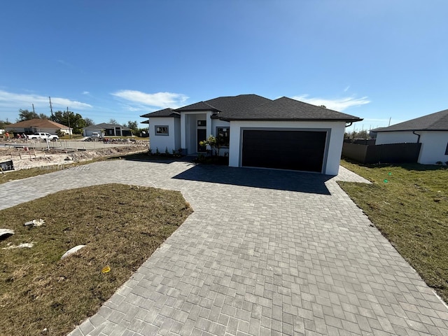 view of front of house with a garage and a front lawn