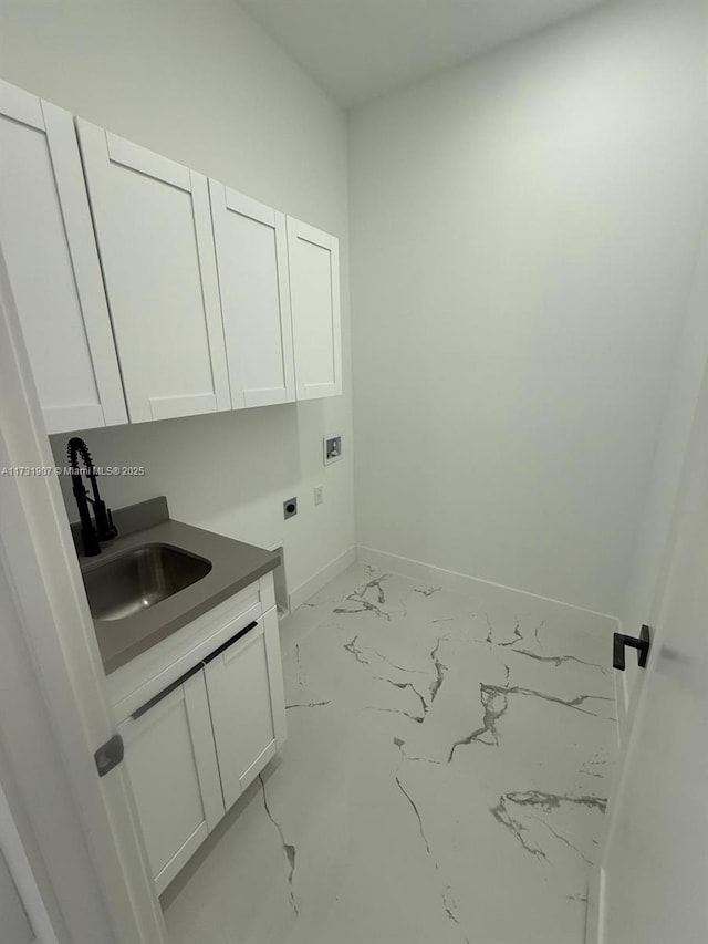 washroom featuring washer hookup, sink, cabinets, and hookup for an electric dryer