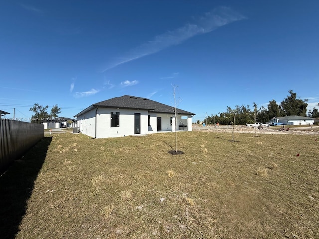 rear view of property with a yard