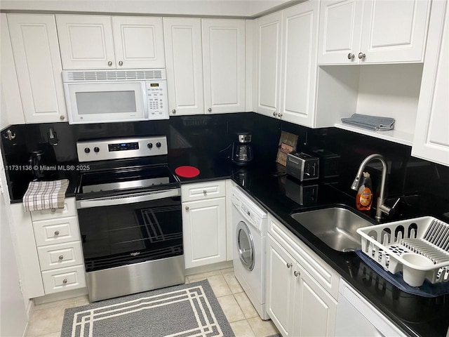 kitchen with stainless steel electric stove, washer / clothes dryer, white cabinetry, sink, and light tile patterned floors