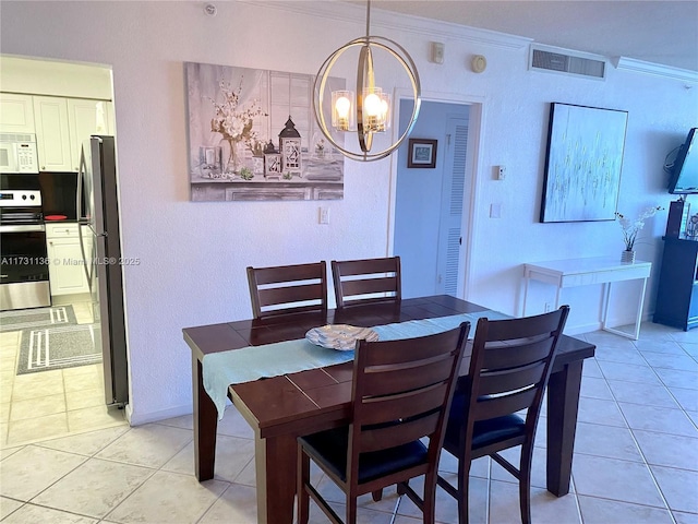 dining area featuring crown molding, light tile patterned floors, and a chandelier