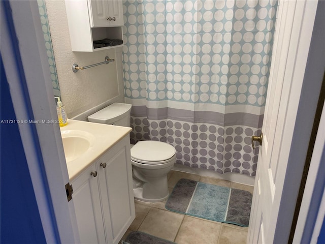 bathroom with tile patterned floors, vanity, and toilet