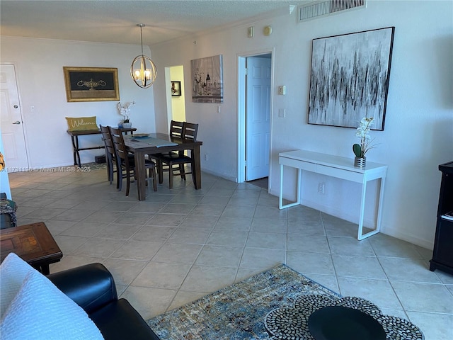 tiled dining space with ornamental molding and an inviting chandelier