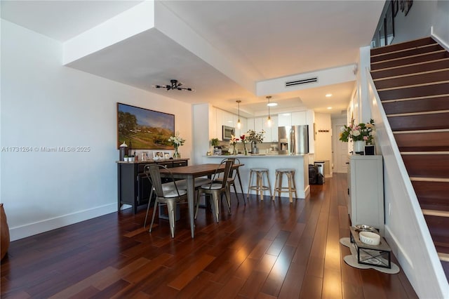 dining area featuring dark wood-type flooring