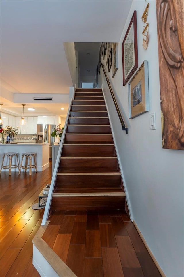 stairway featuring wood-type flooring