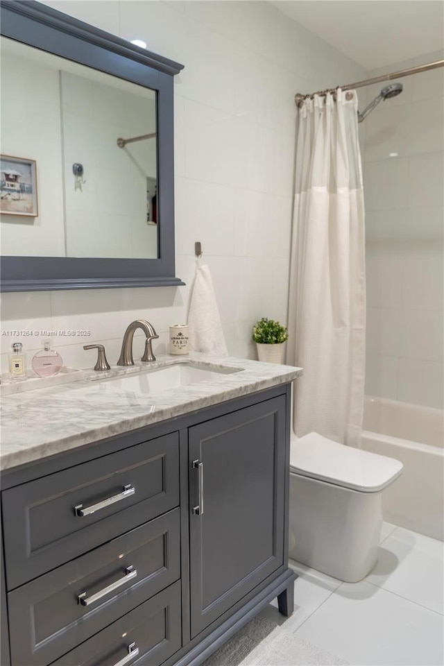 full bathroom featuring vanity, toilet, tile patterned flooring, and shower / bath combo with shower curtain