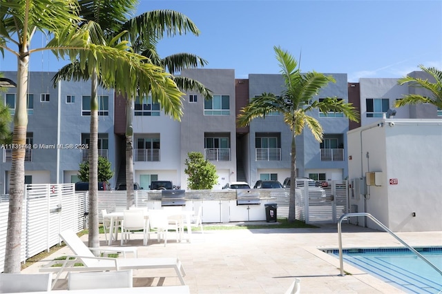 view of swimming pool featuring area for grilling and a patio area