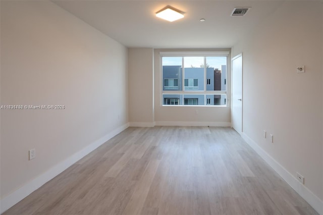 empty room with light hardwood / wood-style flooring