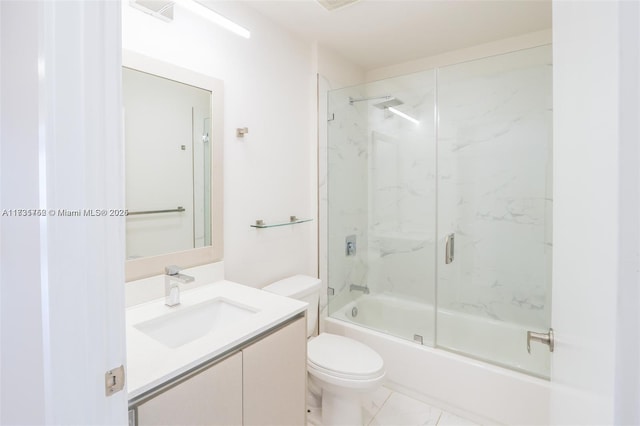 full bathroom with vanity, combined bath / shower with glass door, and toilet