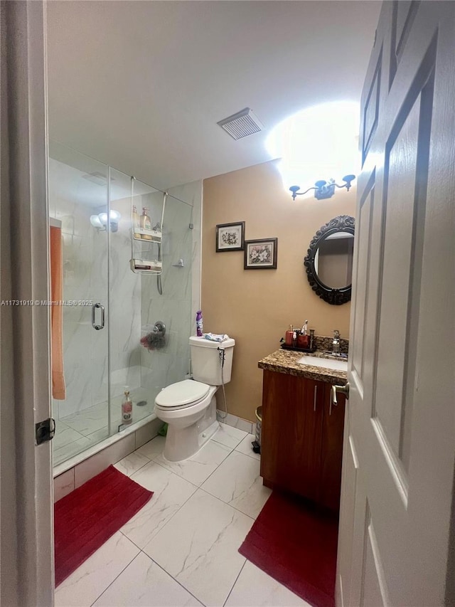 bathroom with vanity, toilet, and an enclosed shower