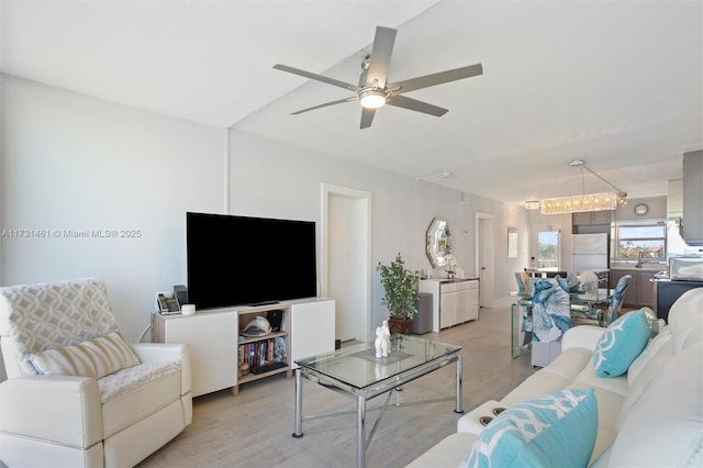 living room with ceiling fan and light hardwood / wood-style flooring