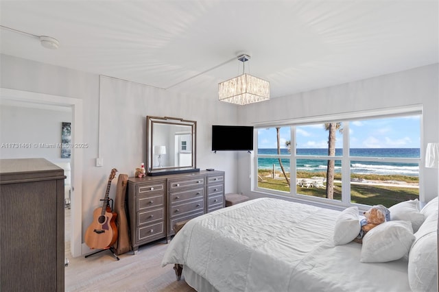 bedroom featuring an inviting chandelier and light hardwood / wood-style floors