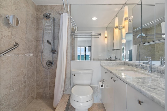 bathroom featuring vanity, tile patterned flooring, toilet, and walk in shower