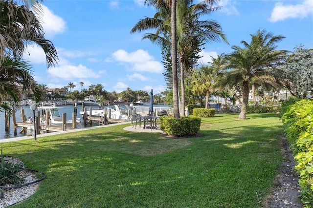 view of yard featuring a water view and a boat dock