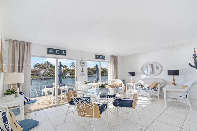 tiled living room featuring a water view