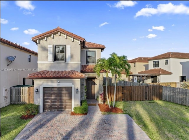 mediterranean / spanish home featuring a garage and a front lawn