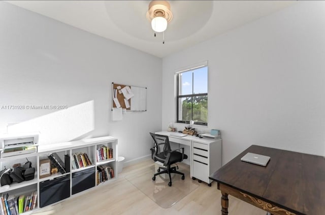 office with light hardwood / wood-style flooring and ceiling fan