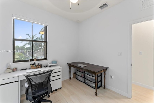 office with light hardwood / wood-style flooring and ceiling fan