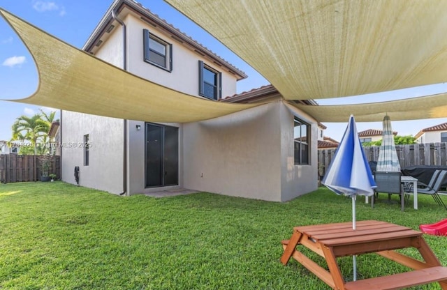 rear view of house with a yard